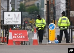 Police officers stand guard close to Victoria Railway Station in Manchester, Britain, May 24, 2017.