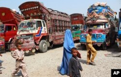 FILE - Afghan refugees living in Pakistan arrive at the UNHCR's Repatriation Center en route to Afghanistan, in Peshawar, Pakistan, Sept. 9, 2016.