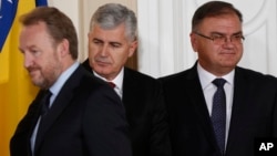 FILE - Members of Bosnia's tripartite presidency, Muslim Bosniak member, Bakir Izetbegovic (L), Croat member Dragan Covic (C) and Serb member, Mladen Ivanic, are seen at the presidency's inauguration ceremony in Sarajevo, Bosnia, Nov. 17, 2014.