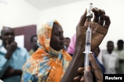 FILE - Staff members of the Teaching Hospital receive the first vaccination treatment for yellow fever in El Geneina, West Darfur, November 14, 2012 handout.