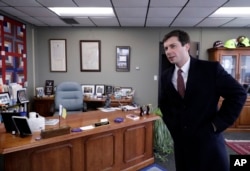 FILE - Mayor Pete Buttigieg talks with an AP reporter at his office in South Bend, Ind., Jan. 10, 2019.
