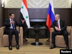 Russian President Vladimir Putin meets with Syrian President Bashar al-Assad in the Black Sea resort of Sochi, Russia, May 17, 2018.