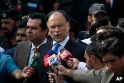 FILE - Pakistani Interior Minister Ahsan Iqbal talks to media in Islamabad, Pakistan, Oct. 2, 2017.