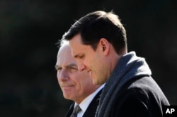 FILE - Then-White House staff secretary Rob Porter (R) walks with White House Chief of Staff John Kelly to board the Marine One on the South Lawn as they leave the White House in Washington, Feb. 2, 2018.