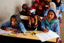 FILE - Afghan girls attend a class at the Aschiana center in Kabul, Afghanistan March 5, 2019.