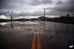 Water covers a closed Las Posas Road near Camarillo, Calif., after heavy rain from the first in a series of El Nino storms passed over the area on, Jan. 6, 2016.