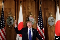 President Donald Trump speaks, accompanied by Japanese Prime Minister Shinzo Abe during a joint news conference at the Akasaka Palace, Monday, Nov. 6, 2017, in Tokyo.