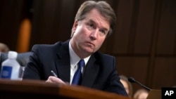 President Donald Trump's Supreme Court nominee, Brett Kavanaugh, takes notes as the Senate Judiciary Committee members make opening statements during his confirmation hearing, on Capitol Hill in Washington, Sept. 4, 2018.