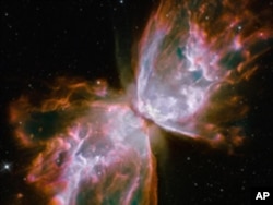 These roiling cauldrons of gas are actually a dying star that was once about five times the mass of the sun. The "butterfly" stretches for more than two million light-years.