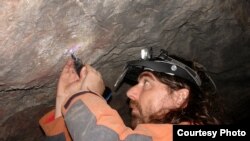 Project leader Alistair Pike of Bristol University removes calcite samples from the cave paintings for dating. As little as 10 milligrams, about the size of a grain of rice, is required. (Marcos Garcia Diez)
