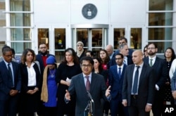 FILE - Omar Jadwat, center, director of the ACLU's Immigrants' Rights Project, speaks at a news conference outside a federal courthouse in Greenbelt, Md.