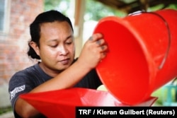 Dayen Cardeno processes coffee beans at a community center in Mindanao, the Philippines, March 26, 2018.