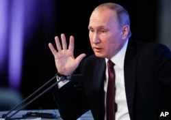 Russian President Vladimir Putin gestures during his annual news conference in Moscow, Russia, Dec. 23, 2016.