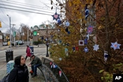 Stars of David hang from bushes outside the post office in the Squirrel Hill neighborhood of Pittsburgh, Nov. 20, 2018. They are part of a Facebook group-initiated project, Jewish Hearts for Pittsburgh. A sign thanks people for participating in an act of Tikum Olam (the Jewish concept of repairing the world) by bringing visual symbols of love to the Pittsburgh community and honoring the memories of the victims of the Tree of Life synagogue shooting.