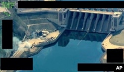 FILE - This photo released March 27, 2017, by the official Twitter account of Operation Inherent Resolve shows the Tabqa Dam, in Raqqa, Syria.