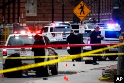 Crime scene investigators collect evidence from the pavement as police respond to an attack on campus at Ohio State University, Nov. 28, 2016, in Columbus.