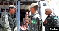 Brazilian soldiers conduct an inspection for the Aedes aegypti mosquito as part of efforts to prevent the spread of the Zika virus, along a street in Sao Paulo, Brazil, Feb. 1, 2016.