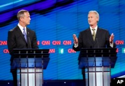 Former Maryland Gov. Martin O'Malley, left, listens as former Rhode Island Gov. Lincoln Chafee speaks during the CNN Democratic presidential debate in Las Vegas, Oct. 13, 2015.