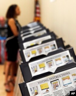 Pamela Hampton votes in Sandy Springs, Ga., May 9, 2018. As the midterm congressional primaries heat up amid warnings of Russian hacking, about 1 in 5 Americans will be voting on machines that do not produce paper records.