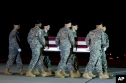 An Army carry team, carries the remains of Army Staff Sgt. Matthew Q. McClintock upon arrival at Dover Air Force Base, Delaware, Jan. 8, 2016.