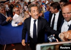 FILE - Nicolas Sarkozy attends his first political rally since declaring his intention to run in 2017 for president, in Chateaurenard, France, Aug. 25, 2016.