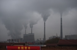 FILE - In this photo taken on Nov. 19, 2015, smoke belches from a coal-fueled power station near Datong, in China's northern Shanxi province.