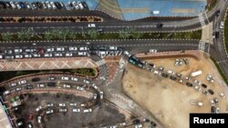 FILE - People queue in their cars to be tested for coronavirus disease (COVID-19) as the country faces a surge in Omicron variant infections in Ashdod, Israel January 3, 2022.