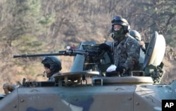 South Korean army soldiers ride an armored vehicle during an annual exercise in Paju, near the border with North Korea, South Korea, Dec. 2, 2016.