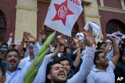 Supporters of Peru's late President Alan Garcia chant slogans during his funeral procession in Lima, Peru, April 19, 2019.