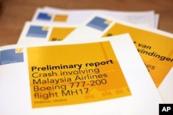 A stack of preliminary reports by the Dutch Safety Board on the crash of Malaysia Airlines flight MH17 is displayed at the board's headquarters in The Hague, Netherlands, Sept. 9, 2014.