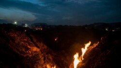 Flames rise out of the fissures on the ground above coal mines in the village of Liloripathra near Dhanbad, an eastern Indian city in Jharkhand state, Sept. 23, 2021. (AP Photo/Altaf Qadri)
