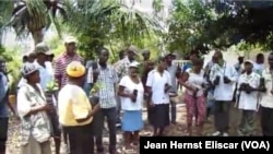 Residents of Beret, Haiti hold seedlings gifted to them by young professionals of Rotaract club.