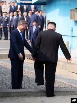 North Korean leader Kim Jong Un crosses the military demarcation line to meet with South Korean President Moon Jae-in at the border village of Panmunjom in the Demilitarized Zone, April 27, 2018.