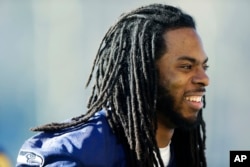 Seattle Seahawks cornerback Richard Sherman walks off the field after football practice, Jan. 24, 2014, in Renton, Washington.
