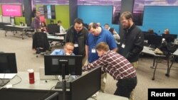 Rigel Preston, seated left, a former surface coal miner, works with other Interapt trainees at the company's office in Paintsville, Kentucky, March 13, 2017. 