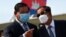 FILE- Cambodia's Minister of Interior Sar Kheng (L) and Prime Minister Hun Sen (R) talk during King Norodom Sihamoni's departure to China for a health check-up at Phnom Penh International Airport in Phnom Penh on October 6, 2020. (Photo by TANG CHHIN Sothy / AFP)