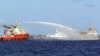 In this photo released by Vietnam Coast Guard, a Chinese ship (L) shoots a water cannon at a Vietnamese vessel (R) while a Chinese Coast Guard ship (C) sails alongside in the South China Sea, off Vietnam's coast, May 7, 2014. 