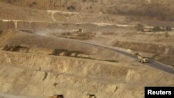 FILE - Trucks are seen at a copper mine in Sarlingyi township March 14, 2013. A number of copper mines in Myanmar were named in the latest list of sanctions issued by the U.S. on July 2, 2021.