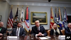 President Donald Trump, center, at the during a healthcare roundtable in the Roosevelt Room of the White House, Wednesday, Jan. 23, 2019, in Washington.