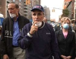 FILE - New York City Mayor Rudolph Giuliani leads New York Gov. George Pataki, left, and Sen. Hillary Clinton, D-N.Y., on a tour of the site of the World Trade Center disaster, Sept. 12, 2001.
