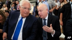 In this June 30, 2019 file photo, U.S. Ambassador to Israel David Friedman, left, and White House Mideast envoy Jason Greenblatt attend the opening of an ancient road at the City of David, a popular archaeological and tourist site.