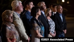 Family members of American citizens killed in Syria by members of an Islamic State group stand before the news media following a hearing at the U.S. Courthouse in Alexandria, Va., Sept. 2, 2021. 