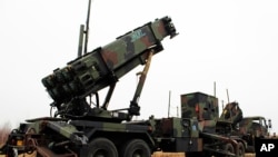 FILE - A camouflaged convoy of Dutch military trucks carrying two batteries of Patriot missiles is lined up for a media opportunity before departing De Peel Air Base in Vreedepeel, southern Netherlands, Jan. 7, 2013.