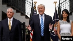 U.S. President Donald Trump, flanked by Secretary of State Rex Tillerson, left, and U.S. Ambassador to the United Nations Nikki Haley, speaks to reporters after their meeting at Trump's golf estate in Bedminster, New Jersey, Aug. 11, 2017. 