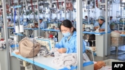FILE - Employees work on a production line of stuffed teddy bears for export at a toy factory in Lianyungang, in eastern China's Jiangsu province on November 22, 2024. 