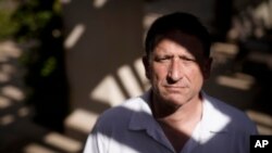 Keith Gartenlaub poses for a pictures near his home Wednesday, March 11, 2020, in Irvine, California.