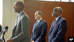 Missouri Department of Public Safety director Daniel Isom, left, speaks as St. Louis Mayor Francis Slay, center, and St. Louis County Executive Charlie A. Dooley listen during a news conference, Nov. 21, 2014, in Clayton, Mo. 
