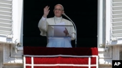 Pope Francis recites the Regina Coeli prayer from his studio's window overlooking St. Peter's Square at the Vatican, May 28, 2017.