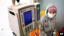 FILE - A young cancer patient is seen at a pediatric oncology clinic in Miami, Florida, Dec. 8, 2014.