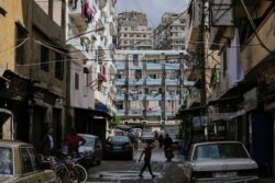 A boy crosses a street at Bab al-Tebanneh, one of Tripoli's poorest slums in the northern city, Lebanon, May 5, 2020.